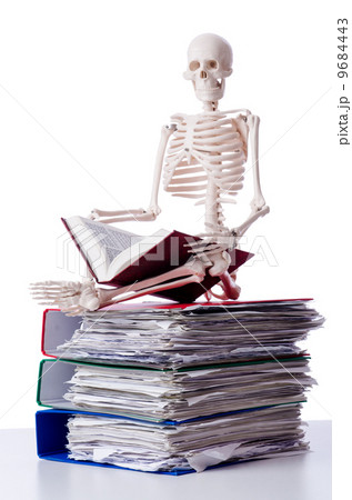 Skeleton with pile of files on white 9684443