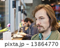 Portrait of a pensive and handsome young man in coffee shop 13864770