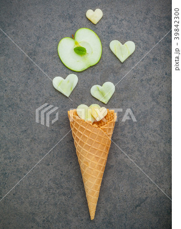 Apple slice in waffle cones and heart shape . 39842300