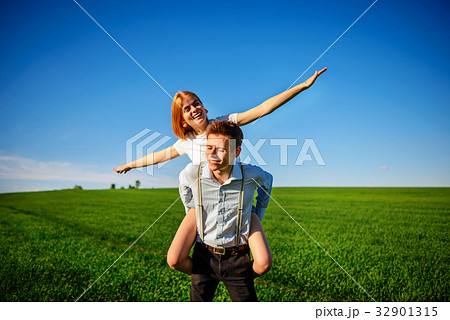 Smiling Man is holding on his back happy woman 32901315