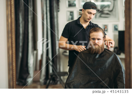 Male client getting haircut by hairdresser. barbershop 45143135