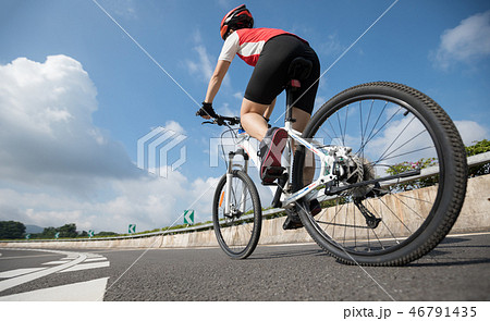 Woman cyclist riding Mountain Bike on highway 46791435