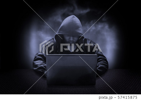 Hooded computer hacker stealing information with 57415875