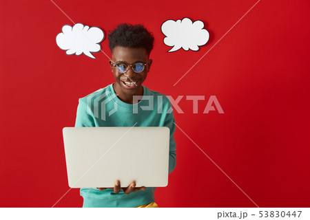 Happy African American man in glasses using laptop 53830447