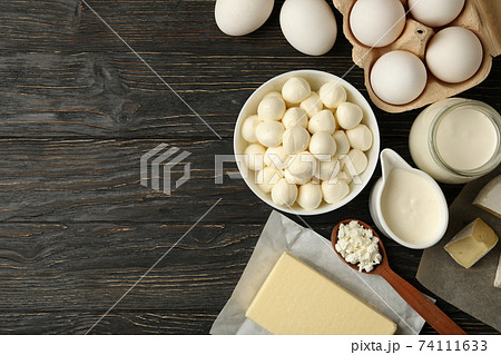 Different fresh dairy products on wooden background, space for text 74111633