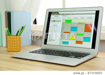 Modern laptop with calendar on screen in office 87359005