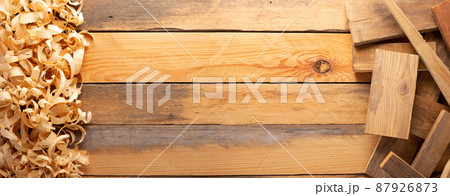 Wood shavings on table background. Wooden shaving at old plank board 87926873