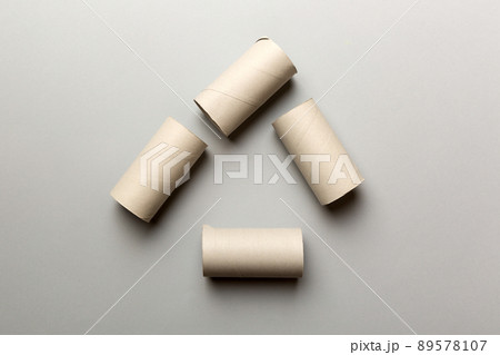 Empty toilet paper roll on colored background. Recyclable paper tube with metal plug end made of kraft paper or cardboard 89578107