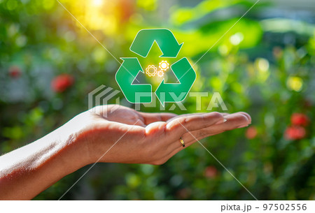 Close up of hand holding green recycle symbol. Recycle concept. 97502556