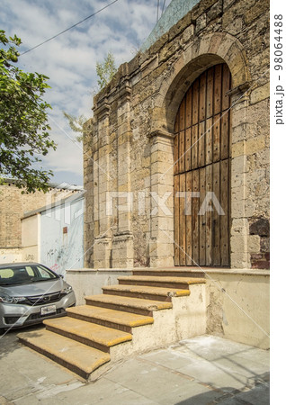 Old building, abandoned, colonial architecture, cantera natural stone walls, aged wooden door 98064488