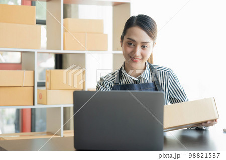 Asian girl working with boxes at home office small business owner start up Entrepreneur, small business, SME or self-employed online and delivery concept 98821537