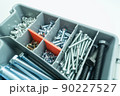 Box organizer for storing bolts of different sizes and other metal fasteners for repairs in the house and workshop. Close-up tool box. Selective focus 90227527