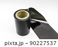 Black thermal transfer ribbon - TTR. Wax thermo ribbon on cardboard reel for barcode. Supply material for printing industry. Selective focus, isolated on white 90227537