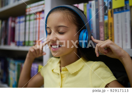 Modern young lady enjoying her favorite song 92917113