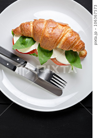 Sandwich croissant in plate for breakfast close up 106367573