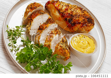 Baked Split Chicken Breasts on plate, top view 106451111