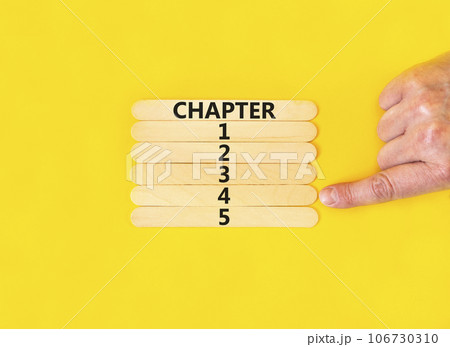 Time to chapter 4 symbol. Concept word Chapter 1 2 3 4 5 on wooden sticks. Businessman hand. Beautiful yellow table yellow background. Business planning and time to chapter 4 concept. Copy space. 106730310