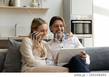 Cheerful family couple using virtual application app on tablet pc 108348844