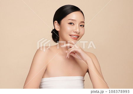 Beautiful young asian woman with clean fresh skin on beige background, Face care, Facial treatment, Cosmetology, beauty and spa, Asian women portrait. 108378993