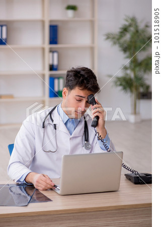 Young male doctor in telemedicine concept 101518905