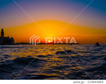 silhouettes of Venice at sunset , view from water 114644968