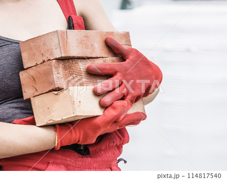 Woman working with bricks 114817540