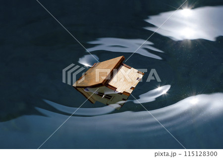 a small wooden house is submerged under water. 115128300