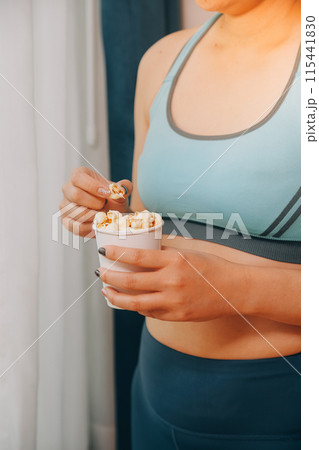 A woman holding a bowl of popcorn 115441830