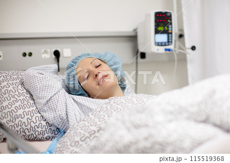 Young woman in hospital recovery room after surgery 115519368