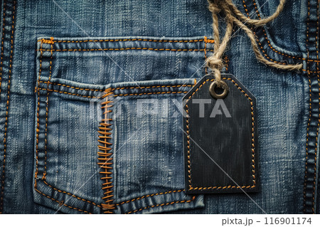 Empty, black, mock up cardboard tag on texture cloth with copy space, blank label on jeans clothes for price, name brand or sale, discount information 116901174