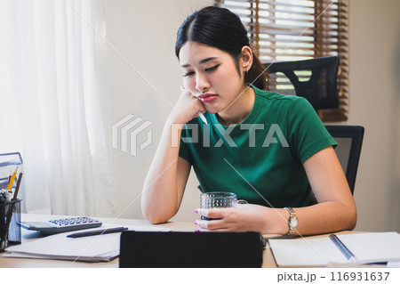 Businesswoman is thinking and is stressed about work. 116931637