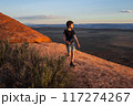 Boy Hiking at Sunset on Devils Garden Trail, Utah 117274267