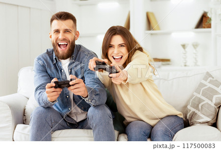 Fans Of Xbox. Crazy Couple Enjoying Playing Videogame On Playstation, Resting At Home 117500083