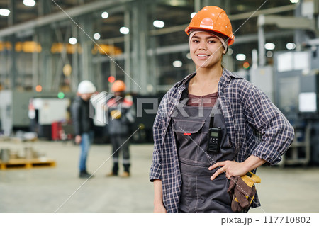 Portrait of Smiling Worker Wearing Safety Helmet 117710802