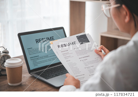 People are reviewing job applications before filling out their resume on the job application form in order to apply for a job at a company. 117834721