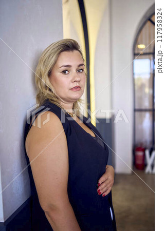 a middle-aged plus size woman in old money style clothes in a fancy restaurant 117958324