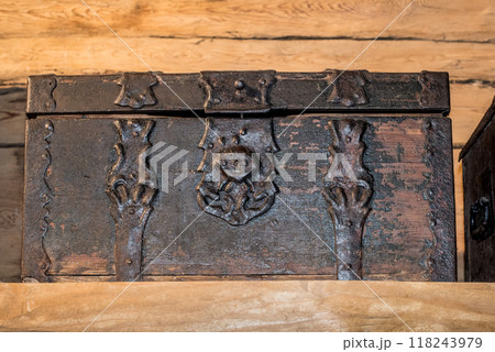 Old wooden chest against wooden wall 118243979