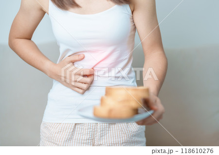 Gluten intolerance, Gluten free and celiac disease or wheat allergy concept. woman hold Bread and having abdominal pain after eat gluten. stomach ache, Nausea, Bloating, Gas, Diarrhea and Skin rash 118610276