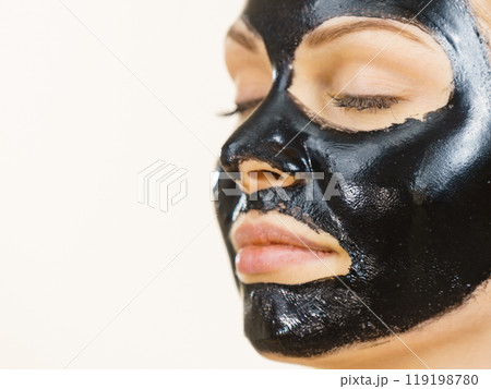 Girl black carbo peel off mask on face 119198780