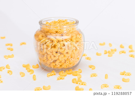 Uncooked Chifferi Rigati Pasta in Glass Jar on White Background 119288057