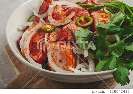 raw meat marinated with spices and onions, for barbecue, sliced meat, pork neck, in a bowl, homemade, no people, 119942455