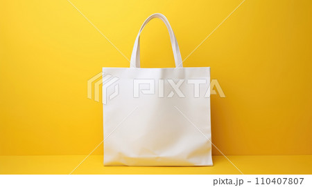 Blank white fabric bag mockup, yellow background 110407807