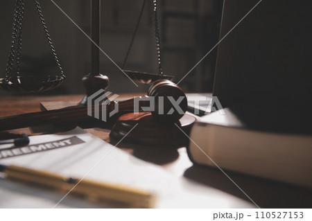 image of judge's hammer, scales lady of justice, law book, laptop computer and contract documents with pen concept of law and justice. 110527153