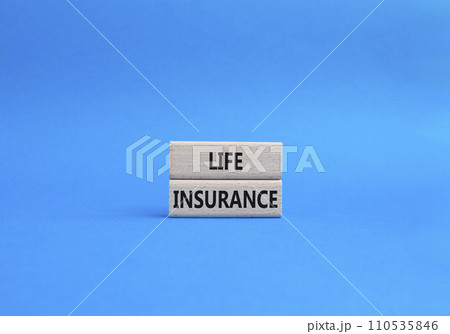 Life insurance symbol. Concept word Life insurance on wooden blocks. Beautiful blue background. Business and Life insurance concept. Copy space 110535846