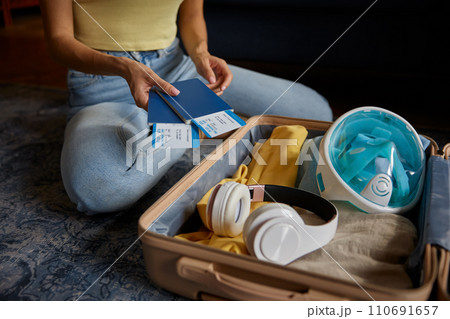 Closeup woman holding travel ticket with boarding pass and passport 110691657