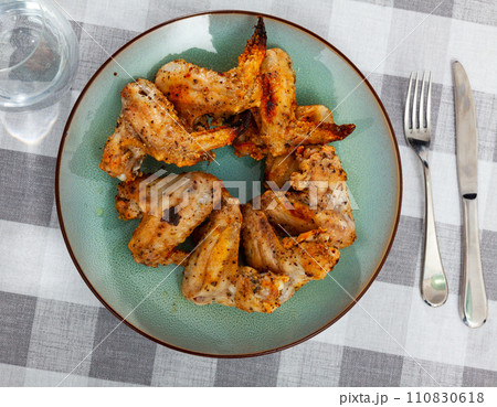 Grilled chicken wings served in the plate 110830618