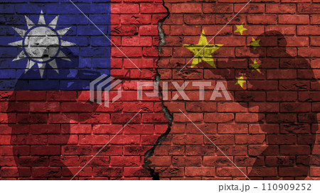 China versus Taiwan, the two flags of the countries on an old brick wall, separated by a crack with the silhouette of military personnel 110909252