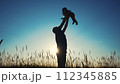 father throws play baby in the park. father's day silhouette happy family child dream concept. father plays with baby throws up. dad play his son in nature in the lifestyle park silhouette at sunset 112345885