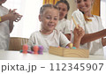 child group playing fishing lifestyle. children in kindergarten play with toys. happy family kid dream concept. a group of children collect building blocks in a kindergarten indoors 112345907