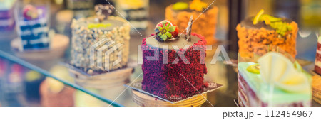 Different types of cakes in pastry shop glass display BANNER, LONG FORMAT 112454967